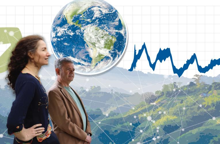 A photo of two faculty members looking out over stylized mountains and the hint of an energy grid