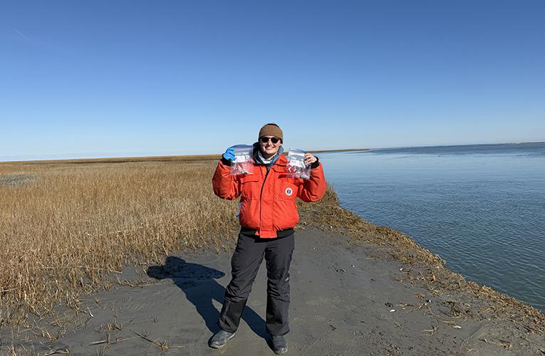 Maddie holding harbor seal scat samples collected at a haul out site in Virginia.