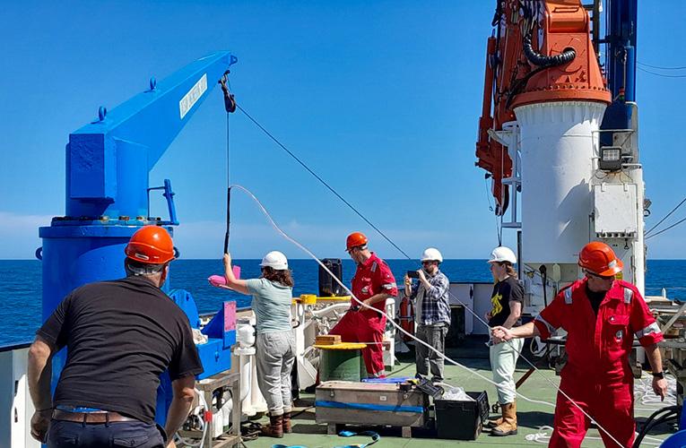 Scientists work aboard research vessel deck